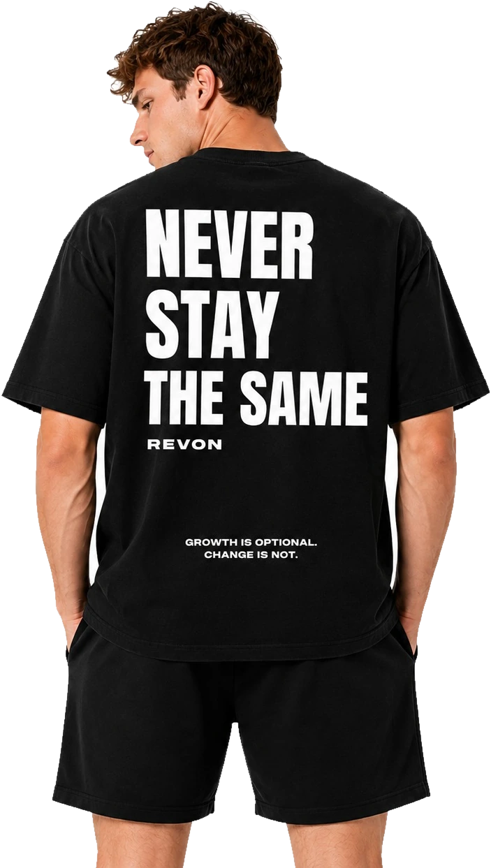 Model seen from behind wearing the black Legacy tee with the Never Stay The Same print